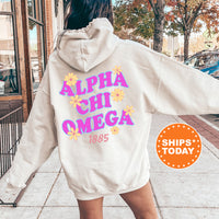 A person wearing a white hoodie with the text 