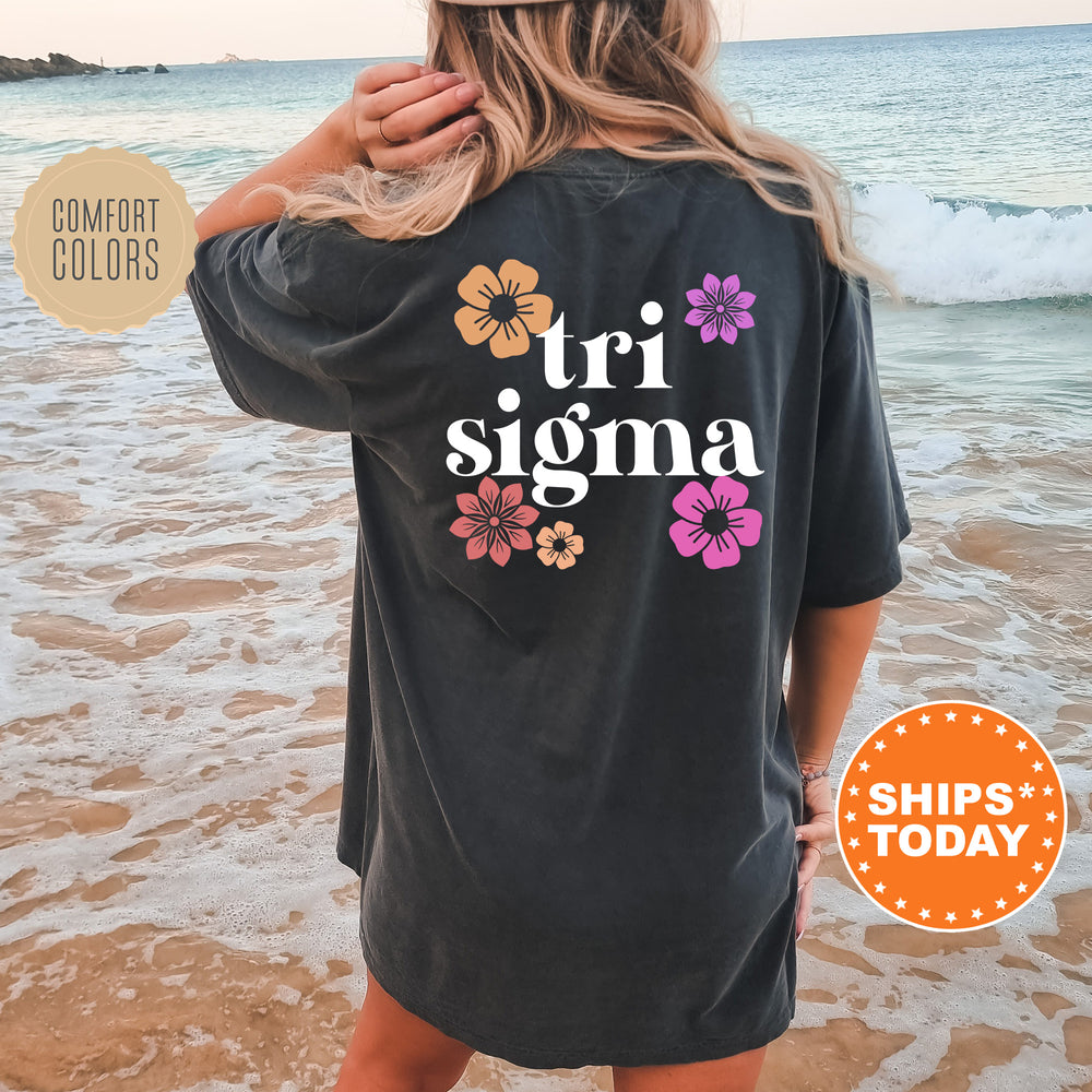 a woman standing on a beach wearing a black shirt
