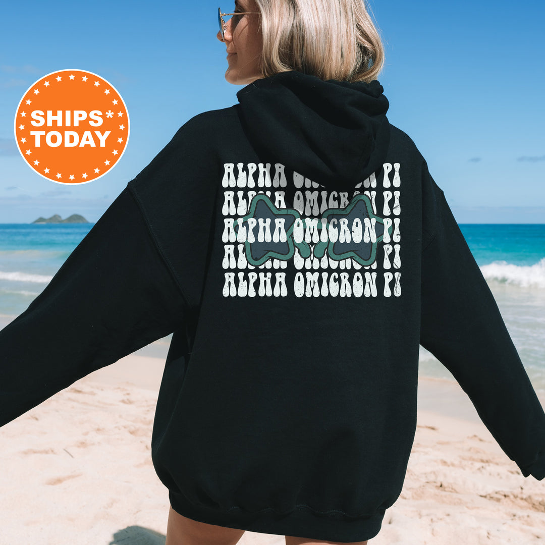 a woman in a black hoodie on the beach