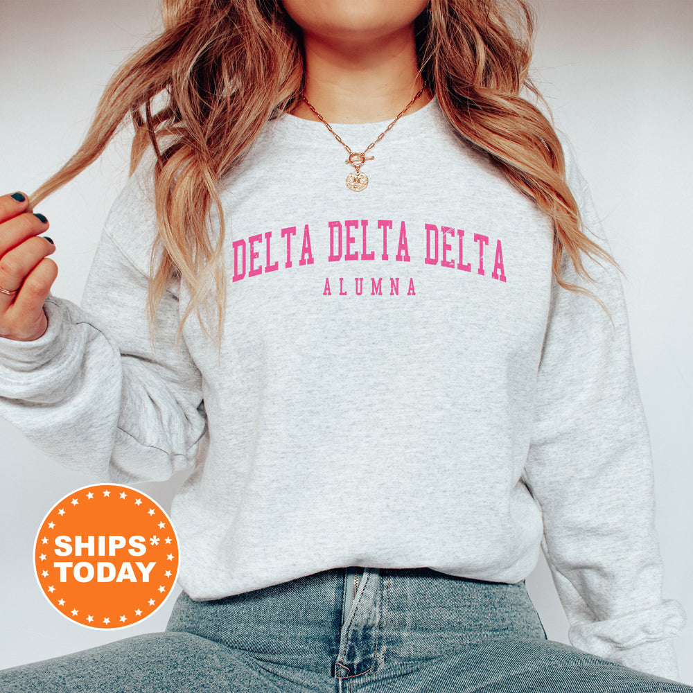 a woman wearing a sweatshirt that says delta delta delta