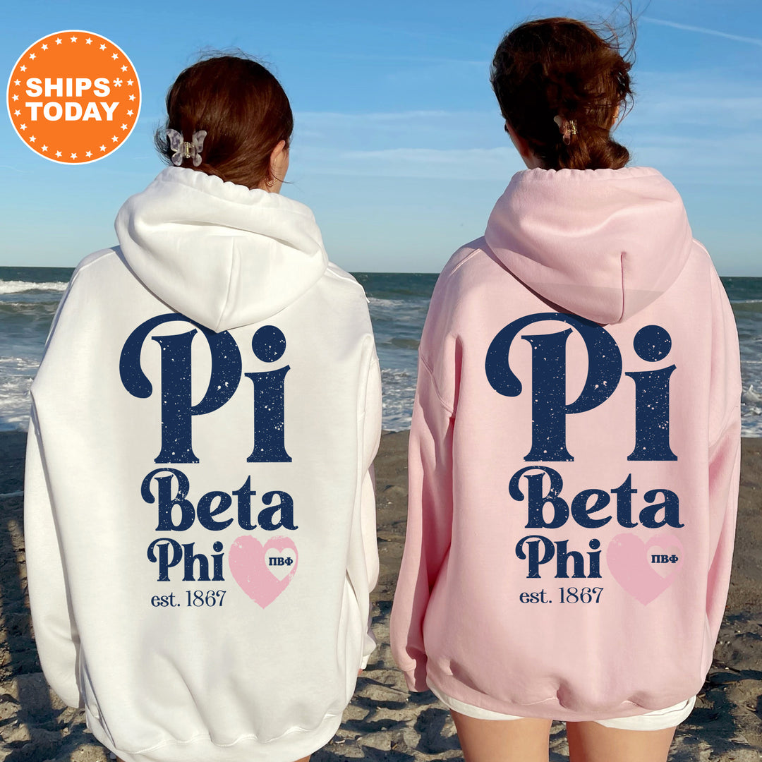 two people wearing matching sweatshirts on the beach