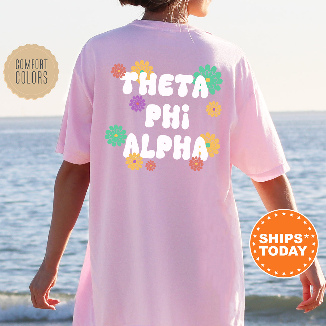 a woman standing on a beach wearing a pink shirt