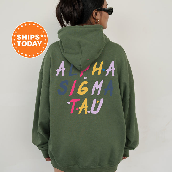 a woman wearing a green hoodie that says aha stigma tau