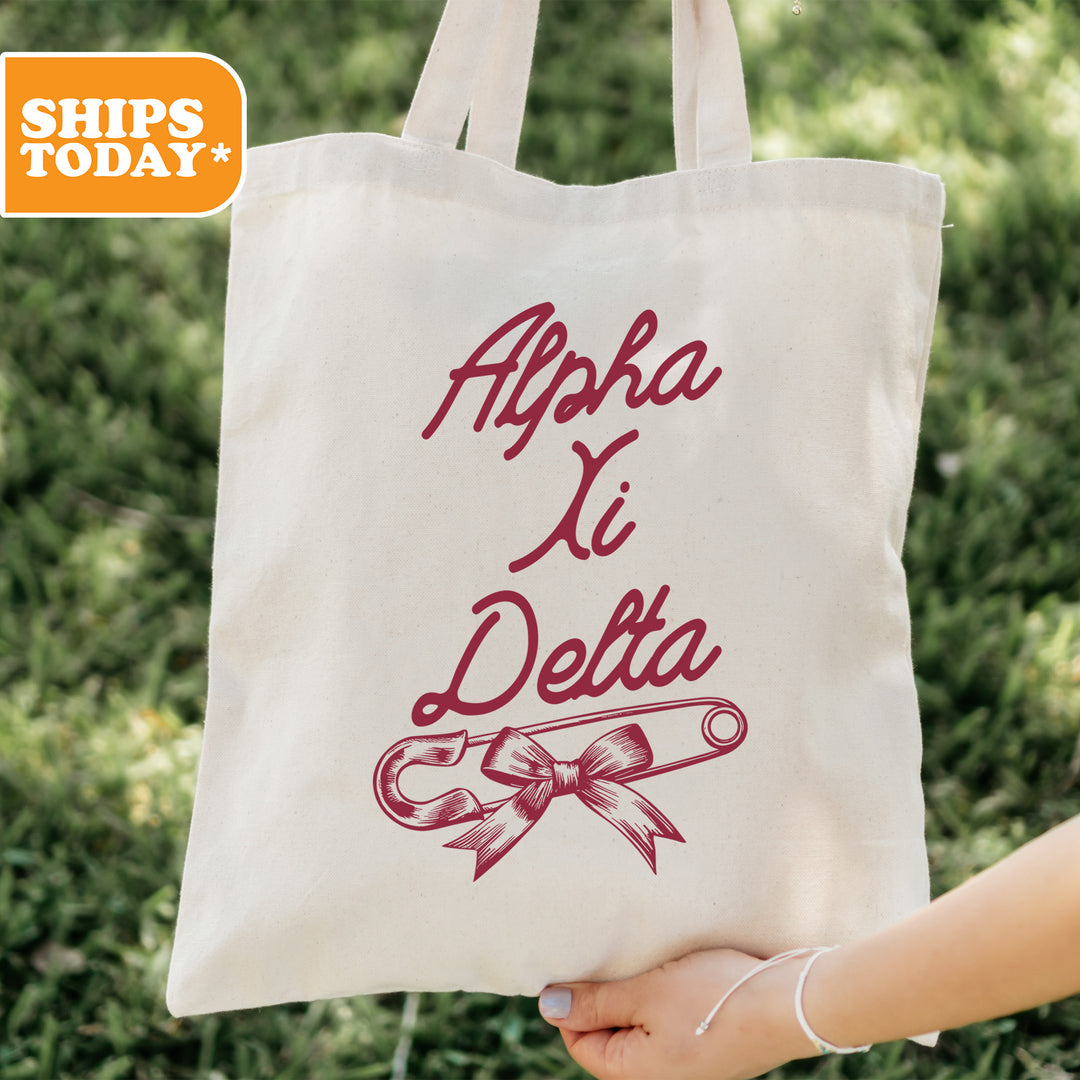 a person holding a tote bag with a ribbon on it
