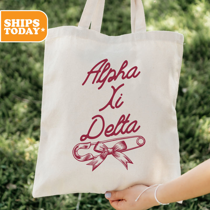 a person holding a tote bag with a ribbon on it