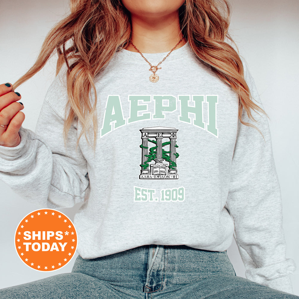 a woman wearing a sweatshirt with the letters aephi on it