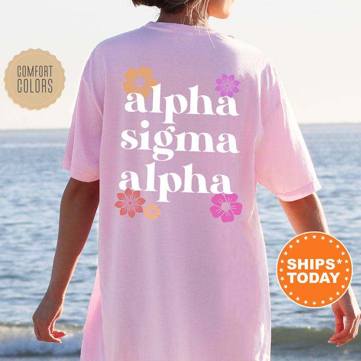 a woman standing on a beach wearing a pink shirt