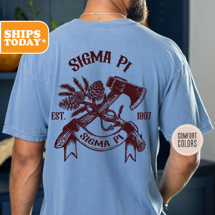 a man wearing a blue shirt with a hammer and pine cone on it