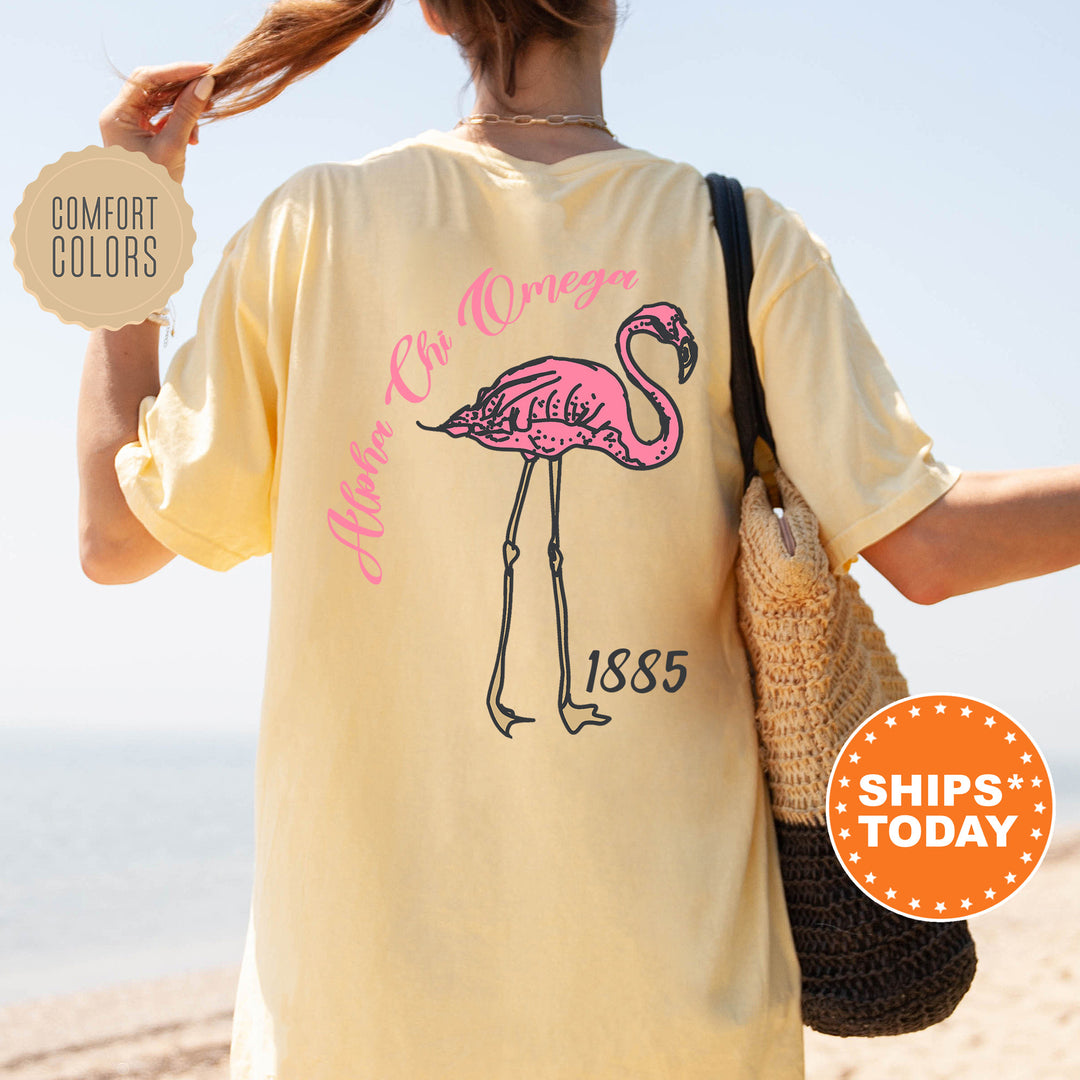 a woman with a pink flamingo on a yellow shirt