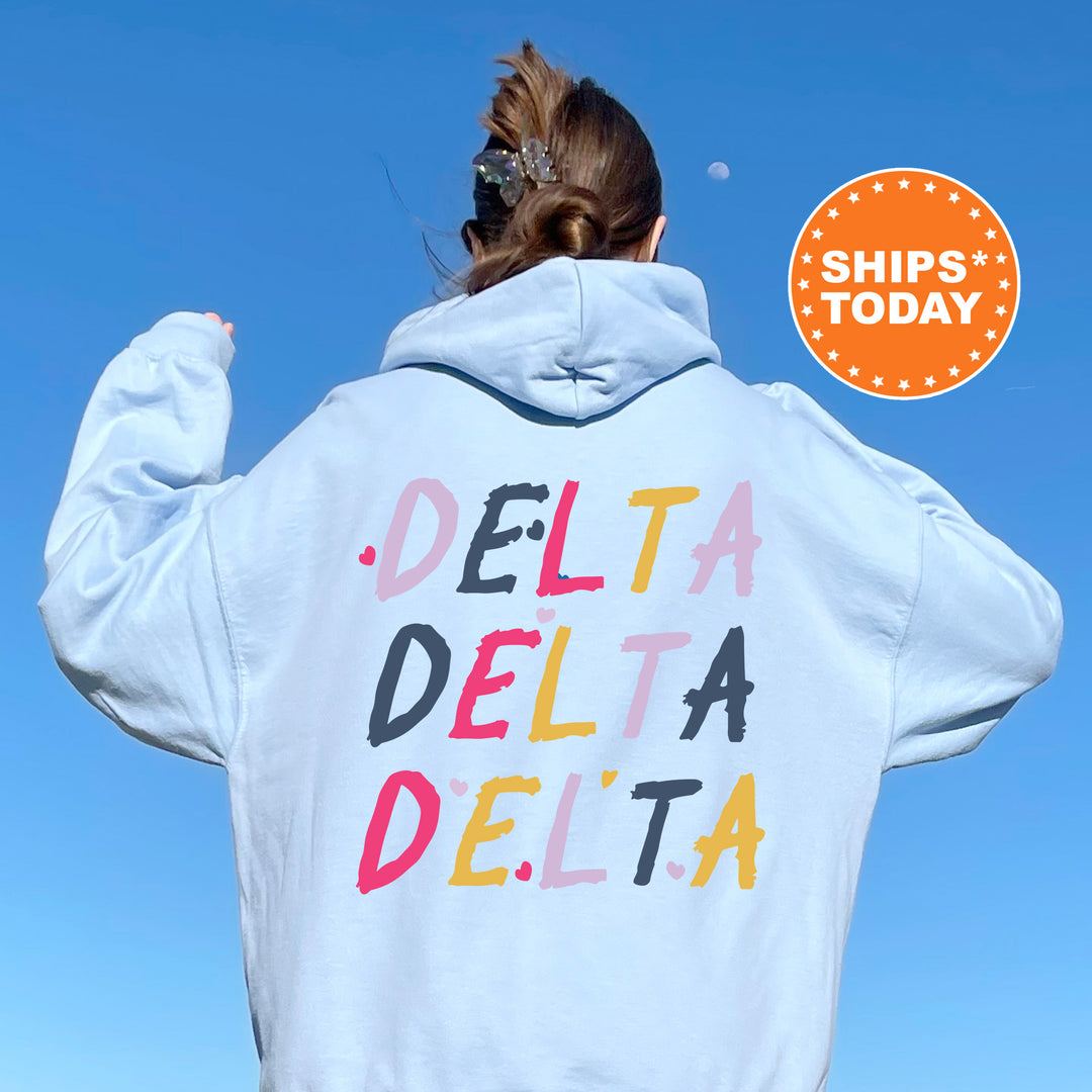 a woman wearing a white hoodie with the words delta delta written on it