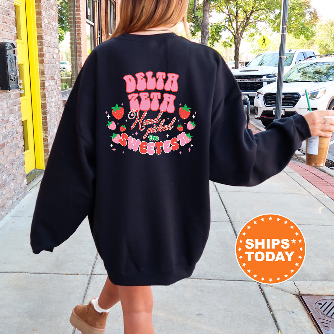 a woman walking down a sidewalk wearing a black sweatshirt