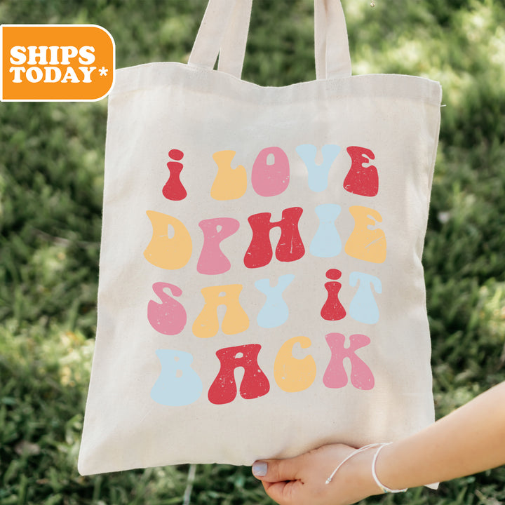 a person holding a tote bag in their hand