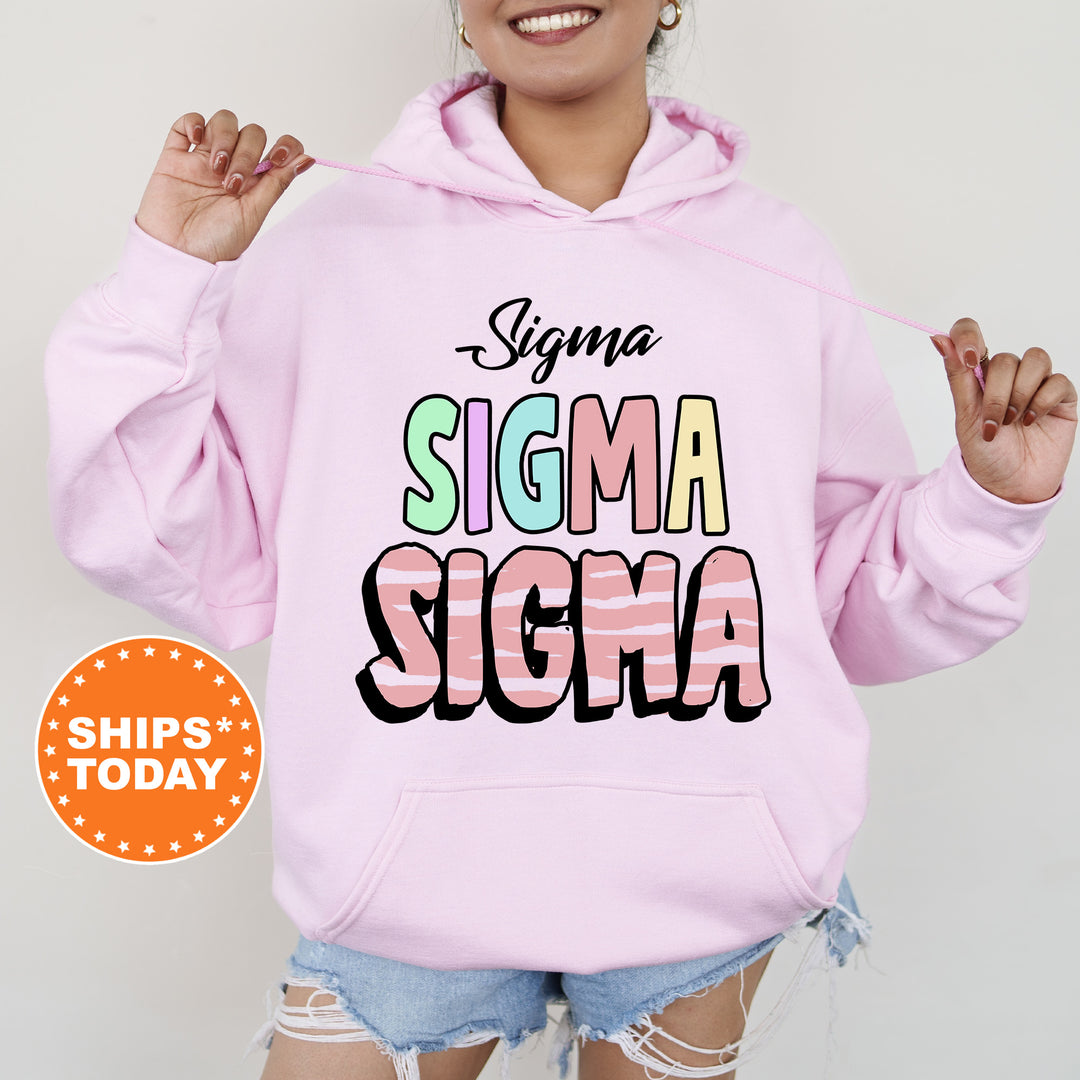 a woman wearing a pink hoodie that says stigmaa stigmaa