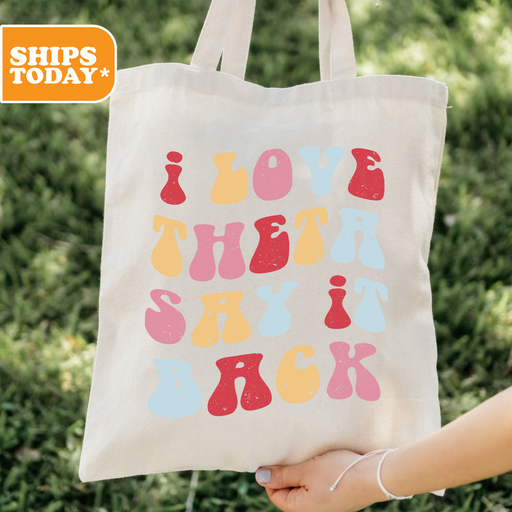 a person holding a tote bag that says love the sky back