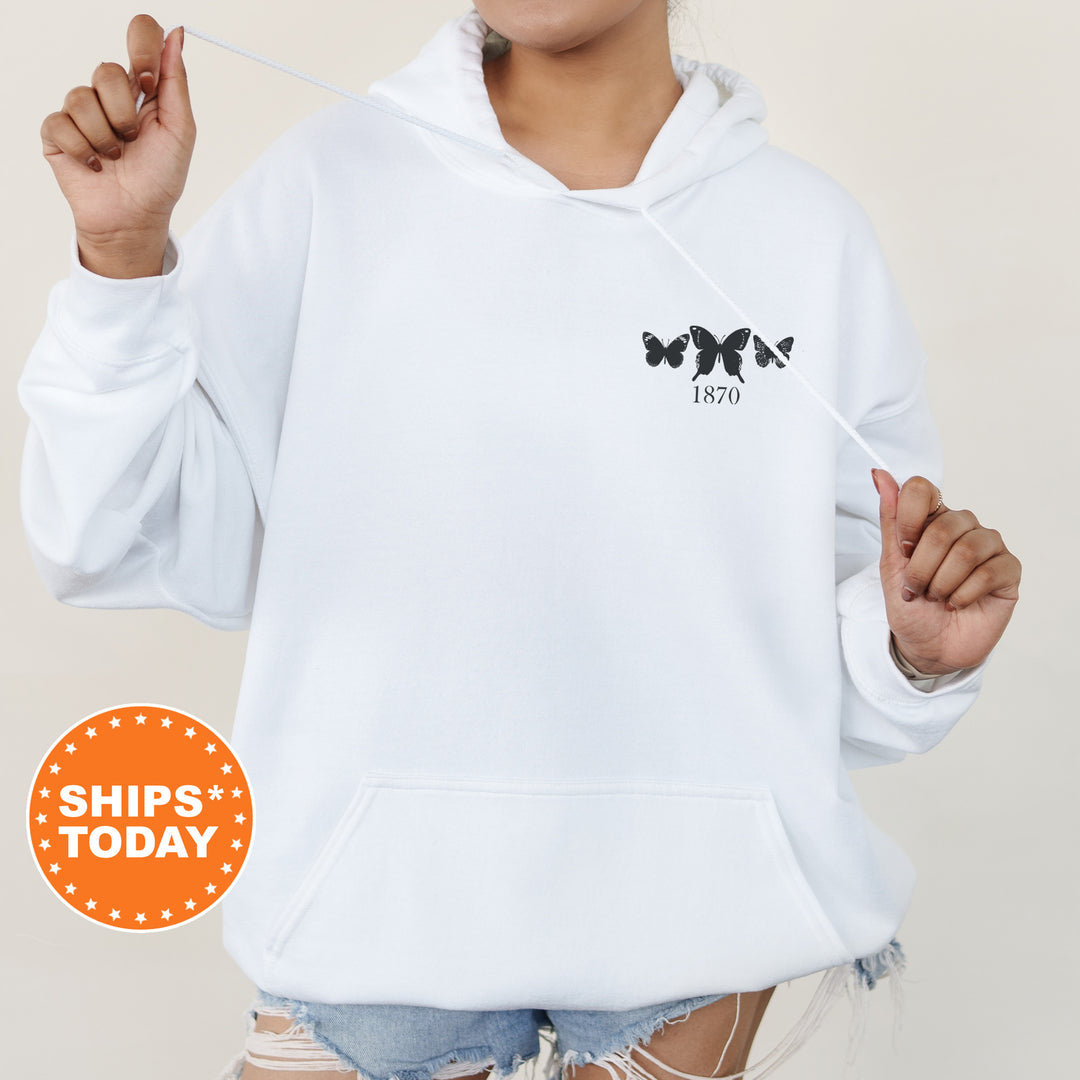 a woman wearing a white hoodie and ripped shorts