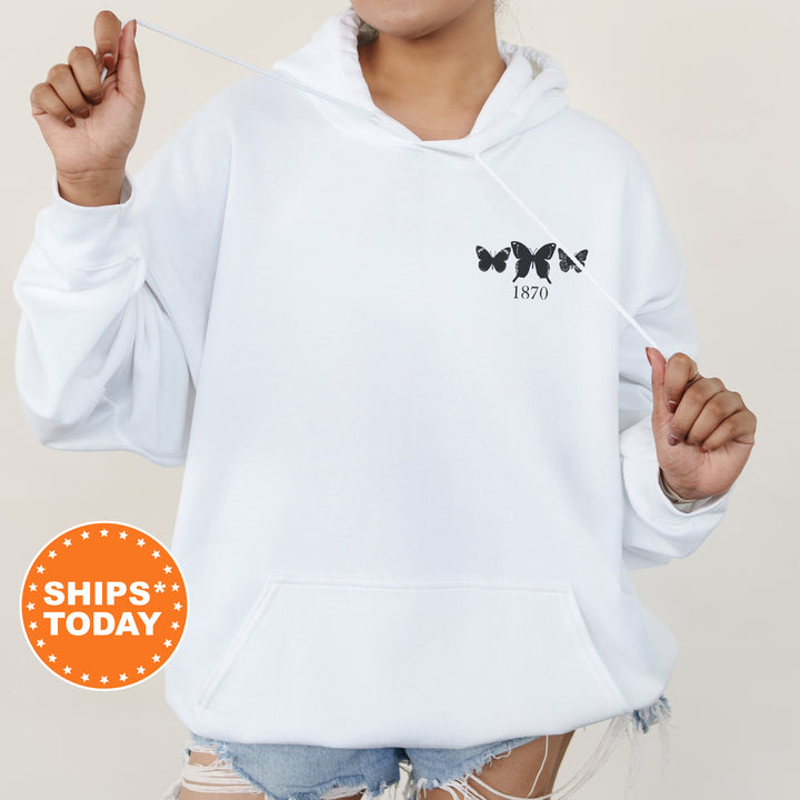 a woman wearing a white hoodie and ripped shorts