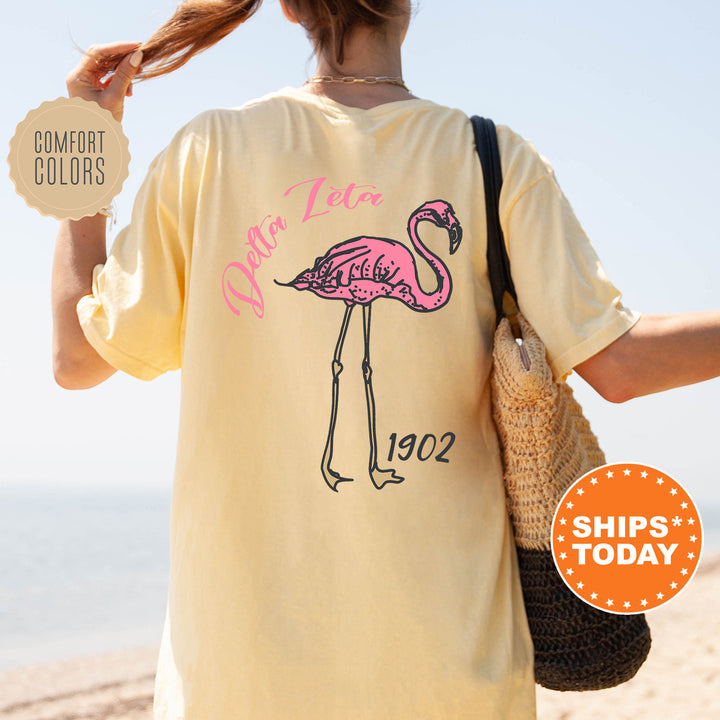 a woman with a pink flamingo on a yellow shirt