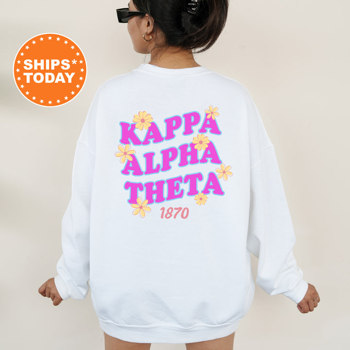A woman wearing a white sweatshirt with the text "KAPPALpha Alpha Theta 1870" printed on it.