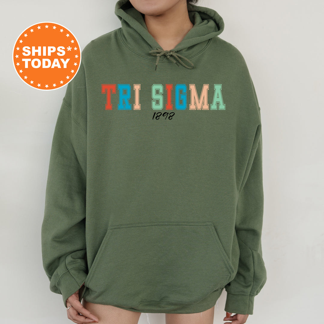 a woman wearing a green sweatshirt with the words tri stigma on it