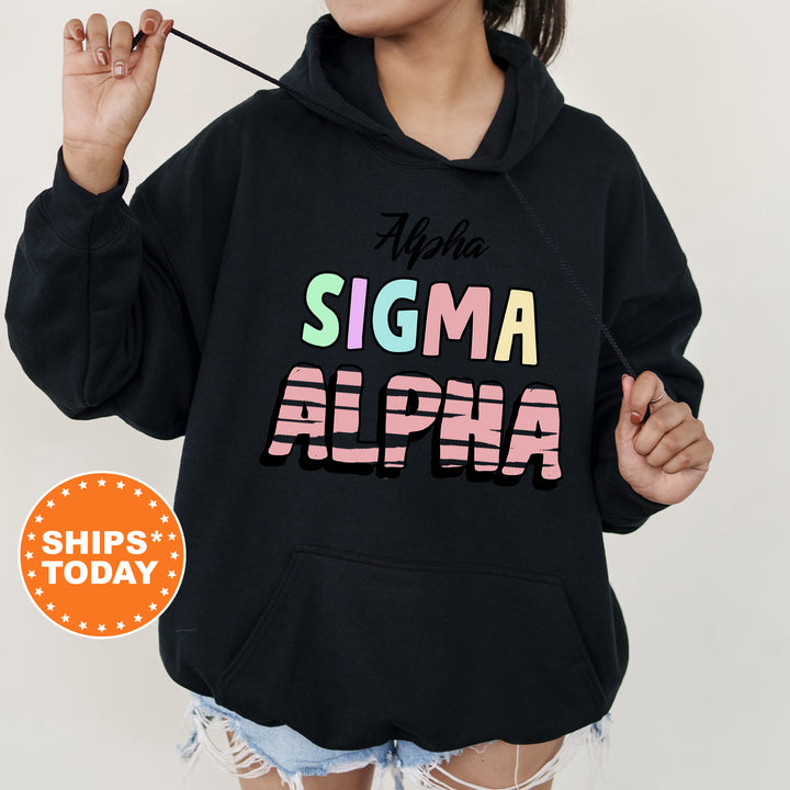 a woman wearing a black hoodie with the word stigmaa on it