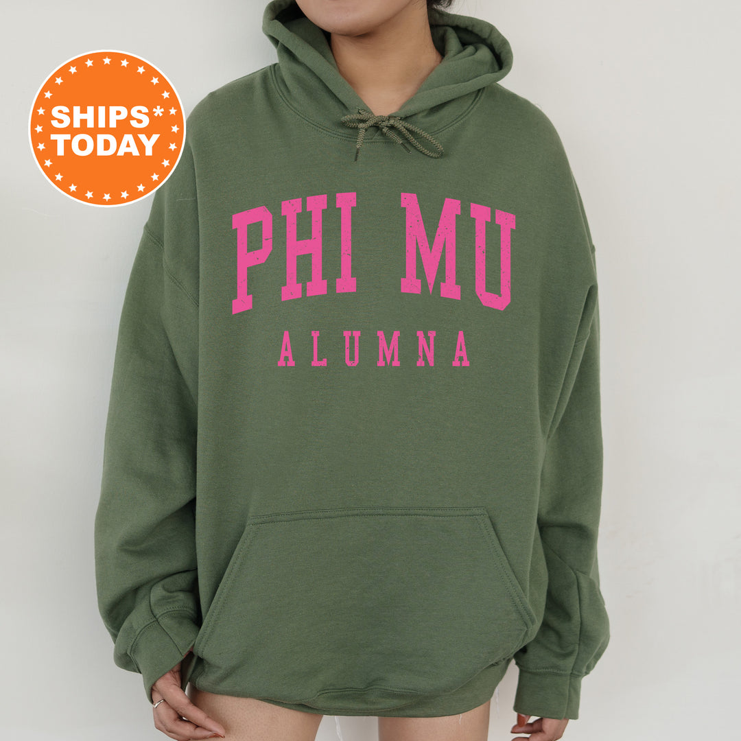 a woman wearing a green hoodie with pink letters on it