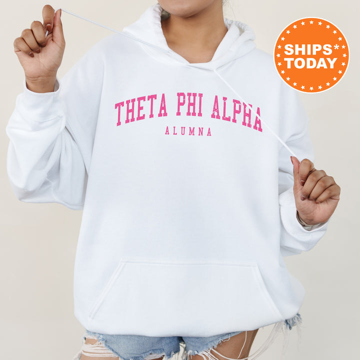 a woman wearing a white hoodie with pink letters on it