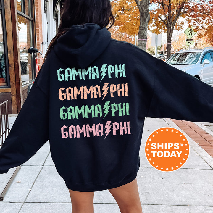 a woman in a black hoodie is walking down the street