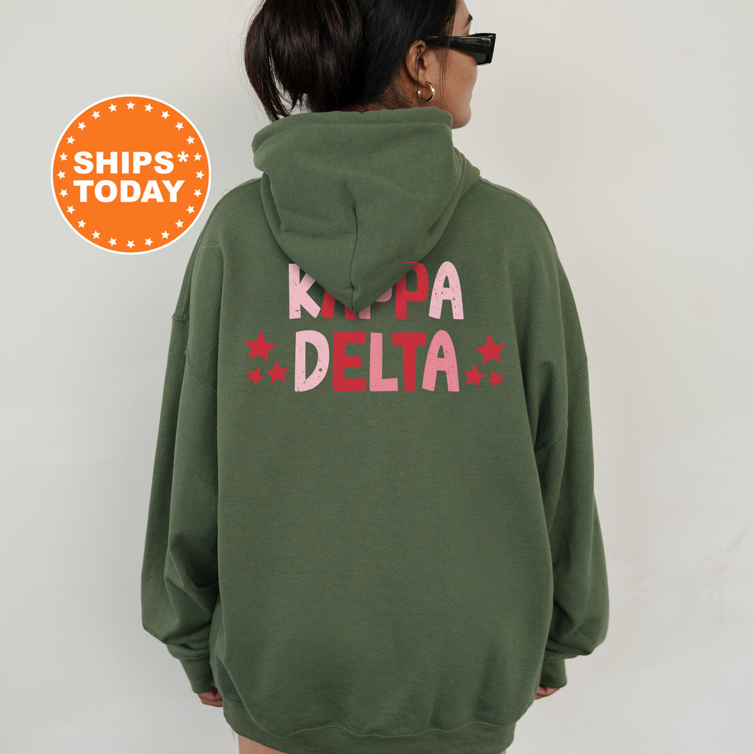 a woman wearing a green hoodie with pink letters on it