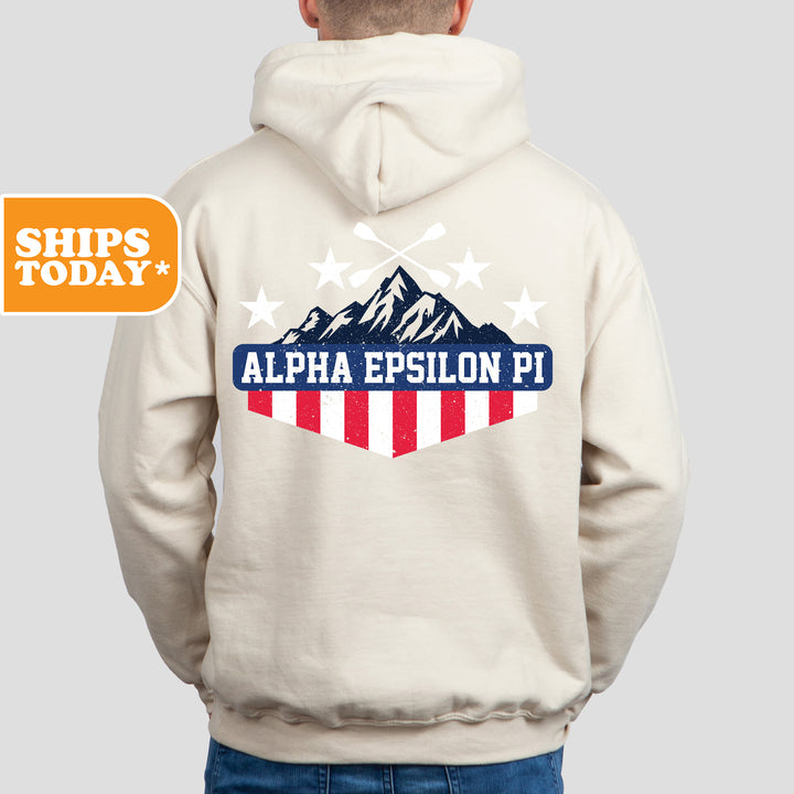 a man wearing a white hoodie with an american flag on it