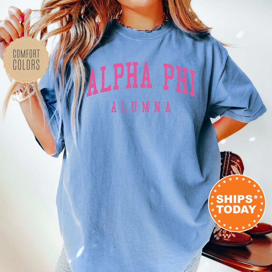 a woman wearing a blue shirt with pink letters on it