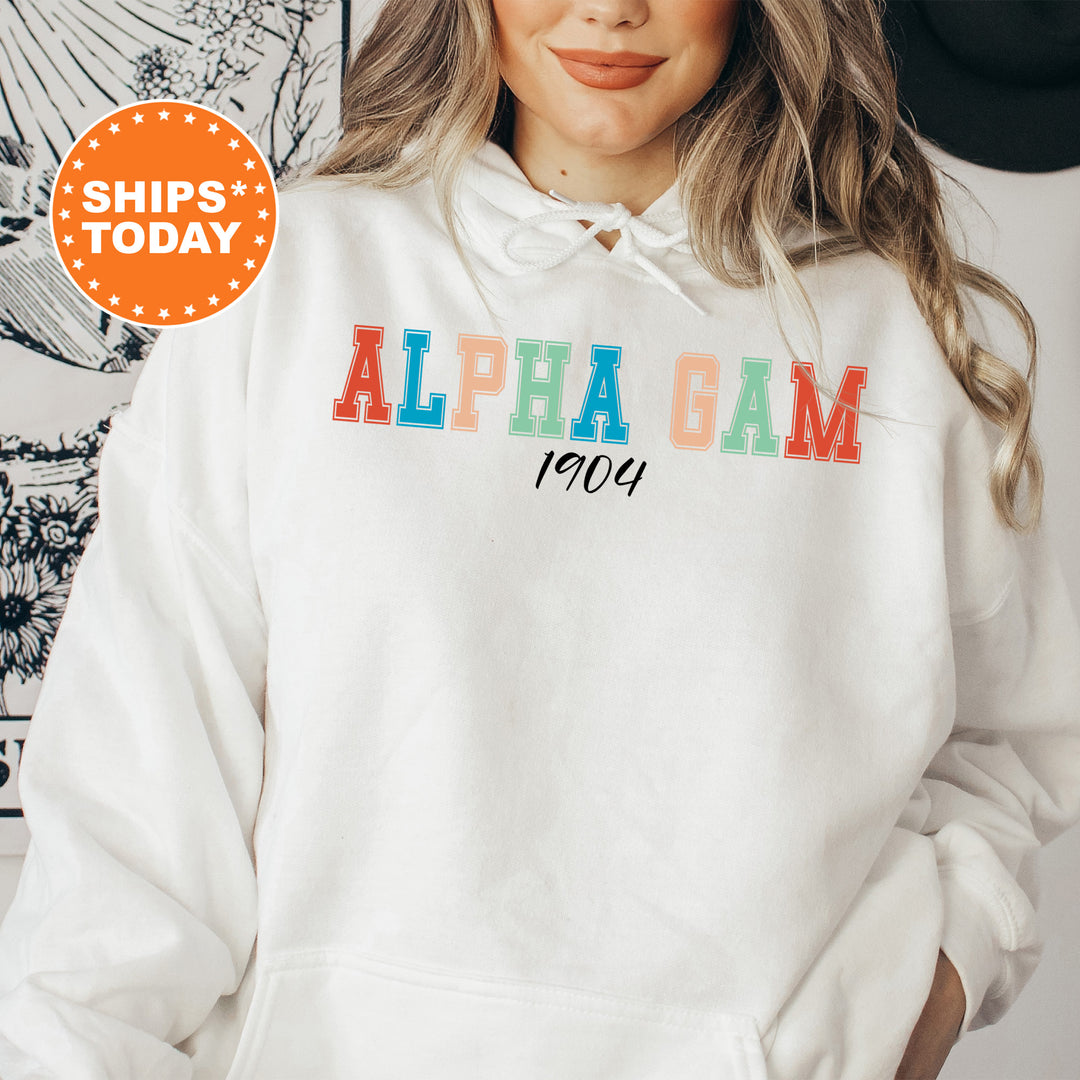 a woman wearing a white hoodie with the words alpha gam printed