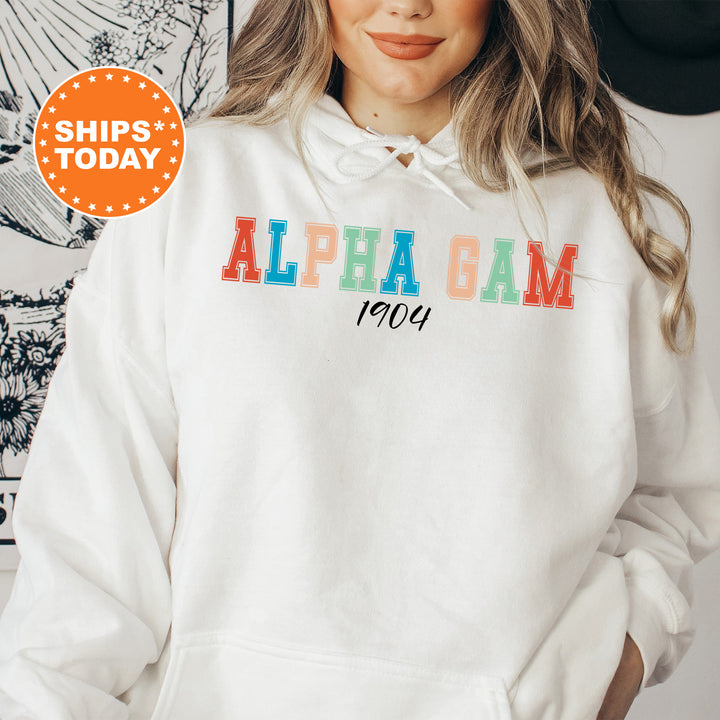a woman wearing a white hoodie with the words alpha gam printed