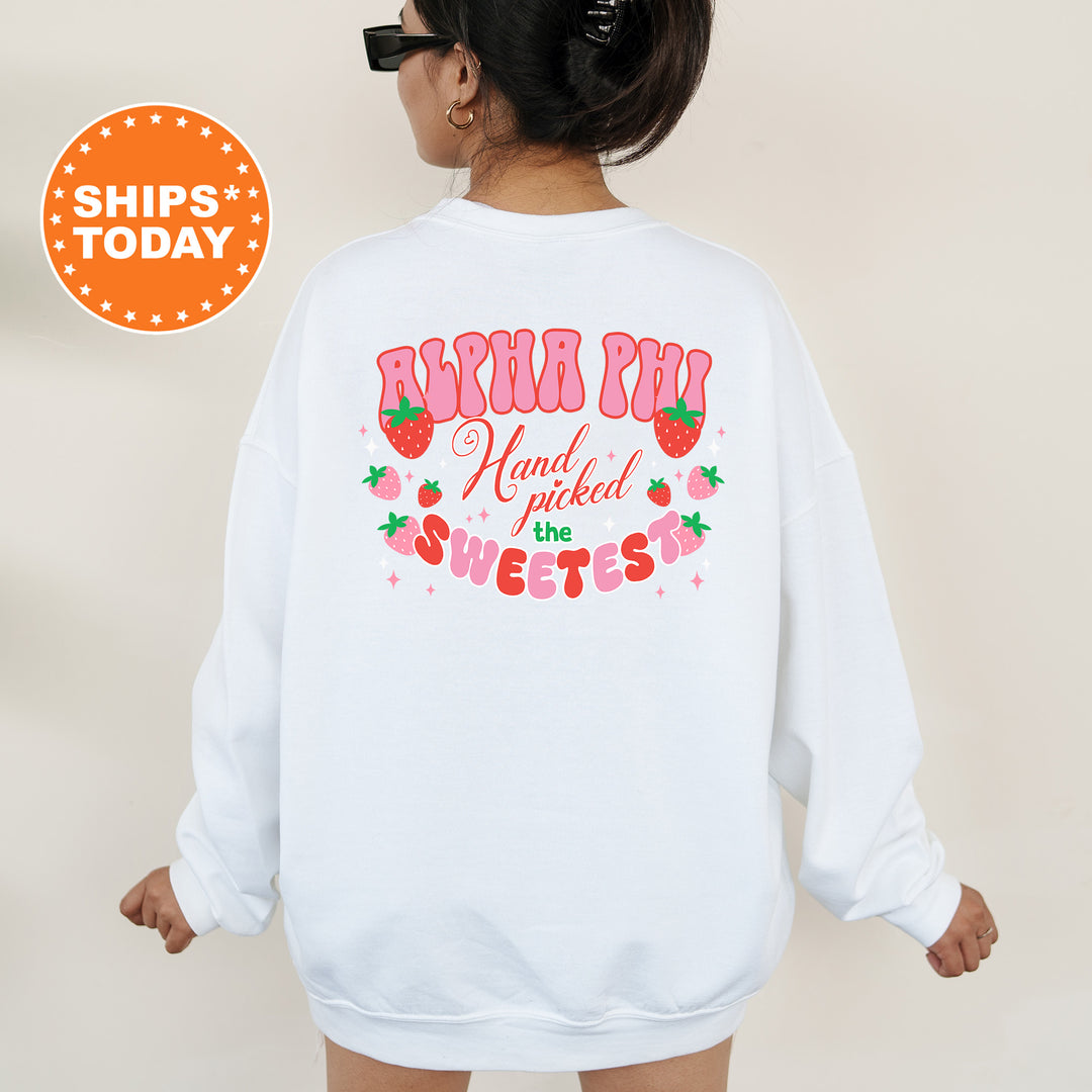 a woman wearing a white sweatshirt with a strawberry print on it