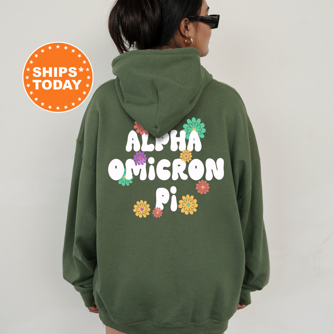 a woman wearing a green hoodie with the words alha omicron pi