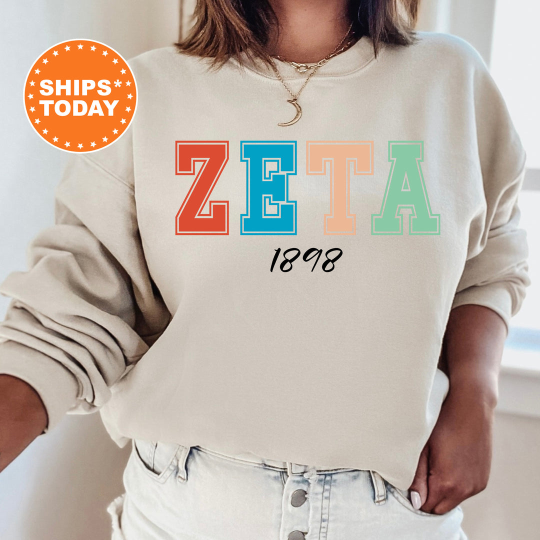 a woman wearing a sweatshirt with the word zeta printed on it