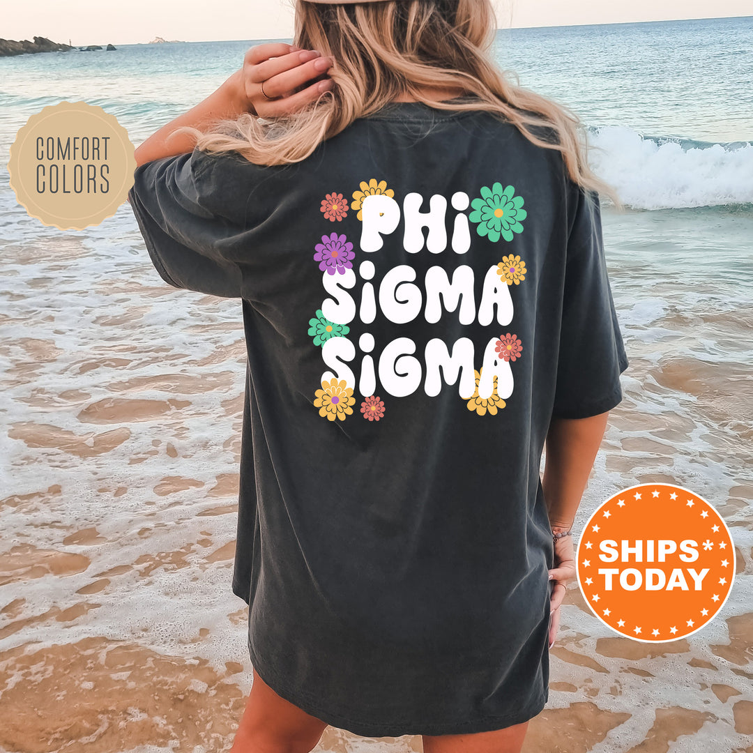 a woman standing on a beach wearing a phi sigma shirt