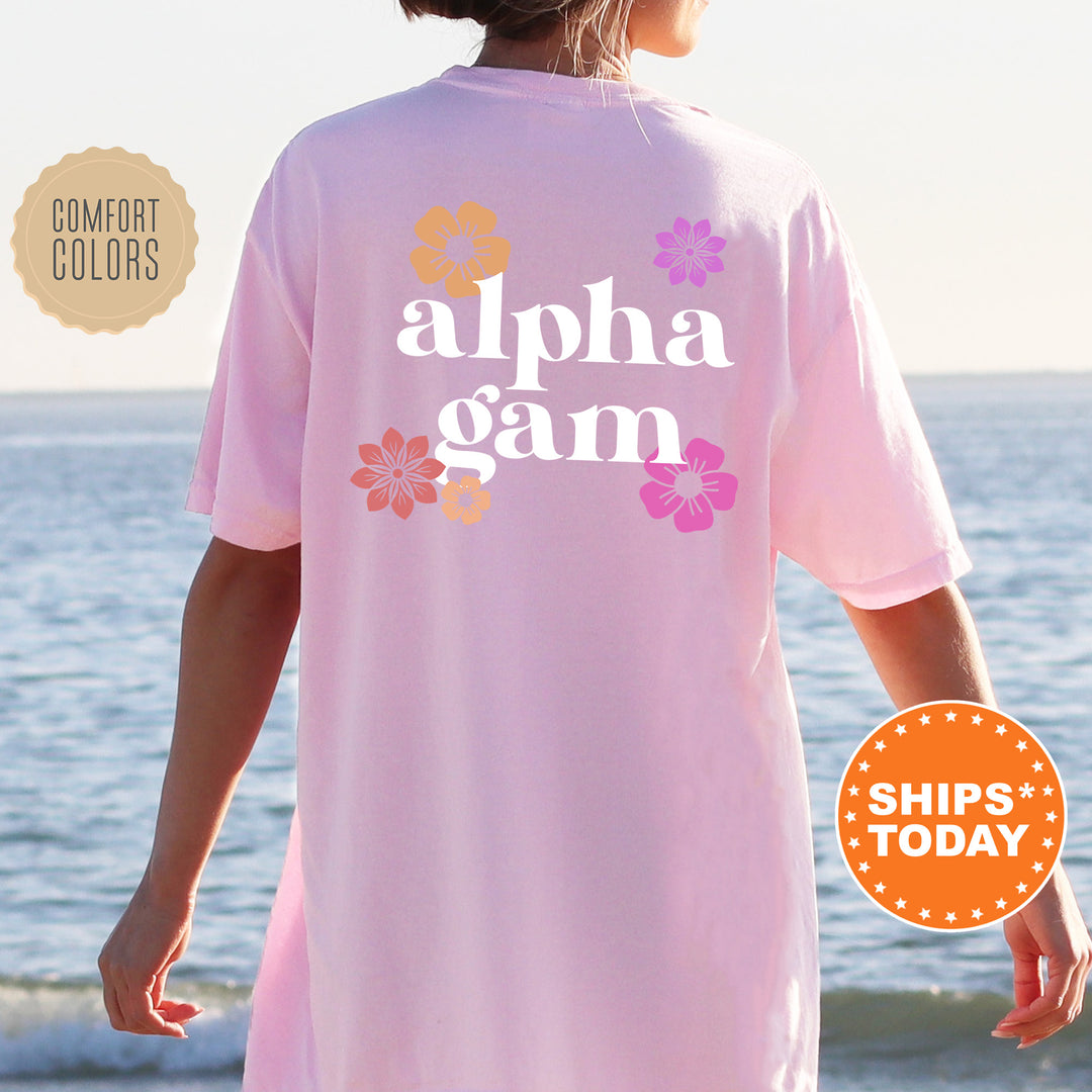 a woman standing on a beach wearing a pink shirt