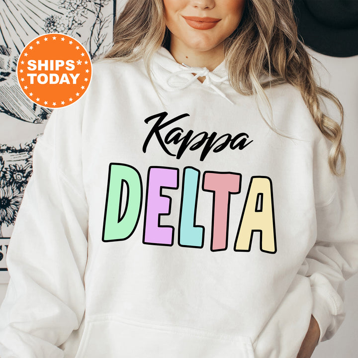 a woman wearing a white hoodie with the words kapa delta printed on it