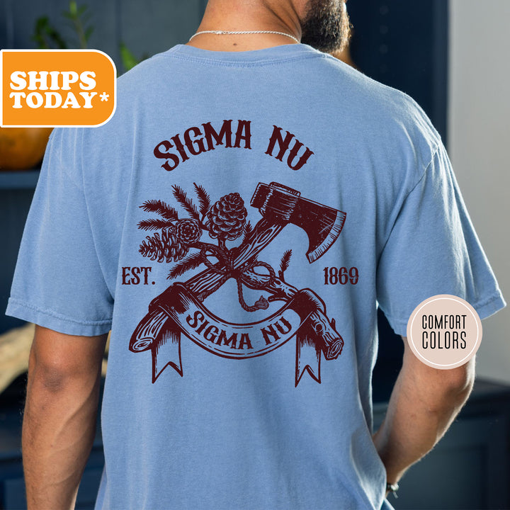 a man wearing a blue shirt with a hammer and pine cone on it