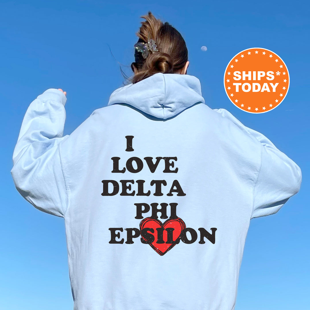 a woman wearing a white hoodie that says i love delta phi epson