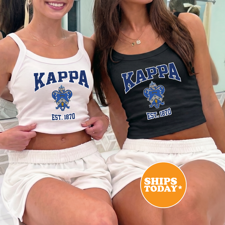 Two women wearing matching Kappa tank tops, one white and one black, are posing together.