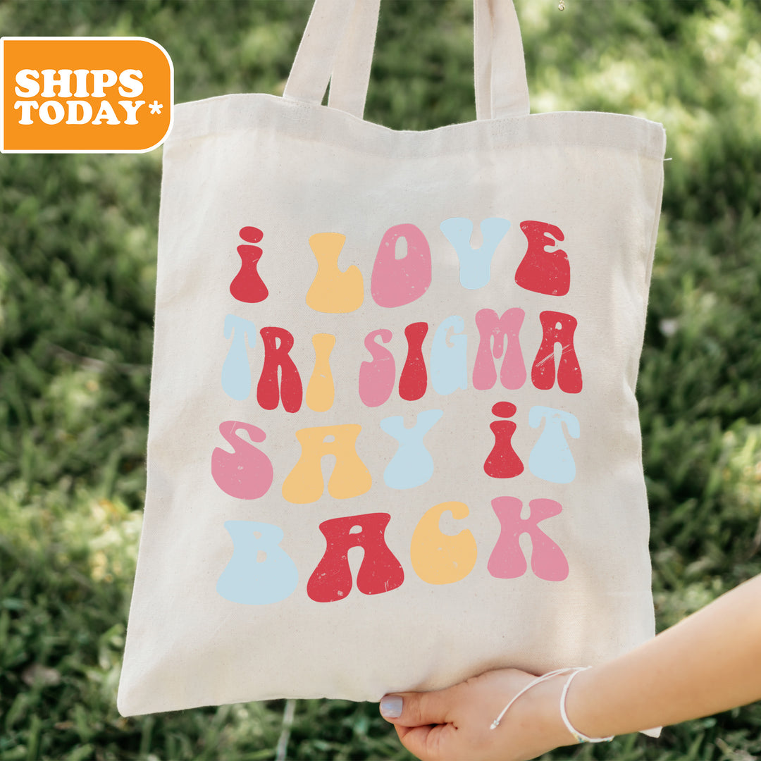 a person holding a tote bag that says love is in the sky