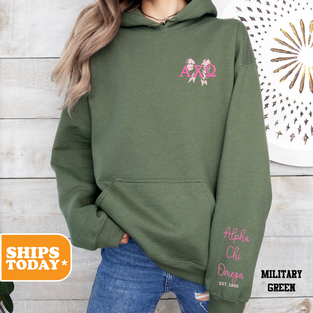 a woman wearing a green hoodie with pink letters on it
