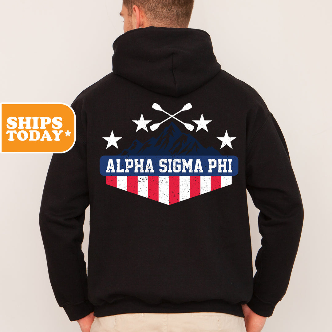 a man wearing a black hoodie with an american flag on it