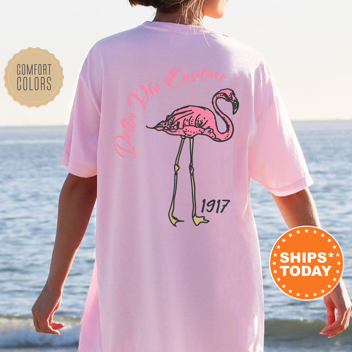 a woman wearing a pink shirt with a pink flamingo on it