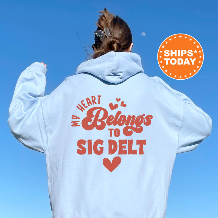 a woman wearing a white hoodie that says, i heart belongs to sig