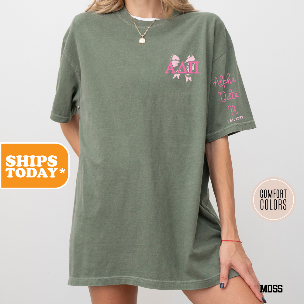 a woman wearing a green shirt with pink flowers on it
