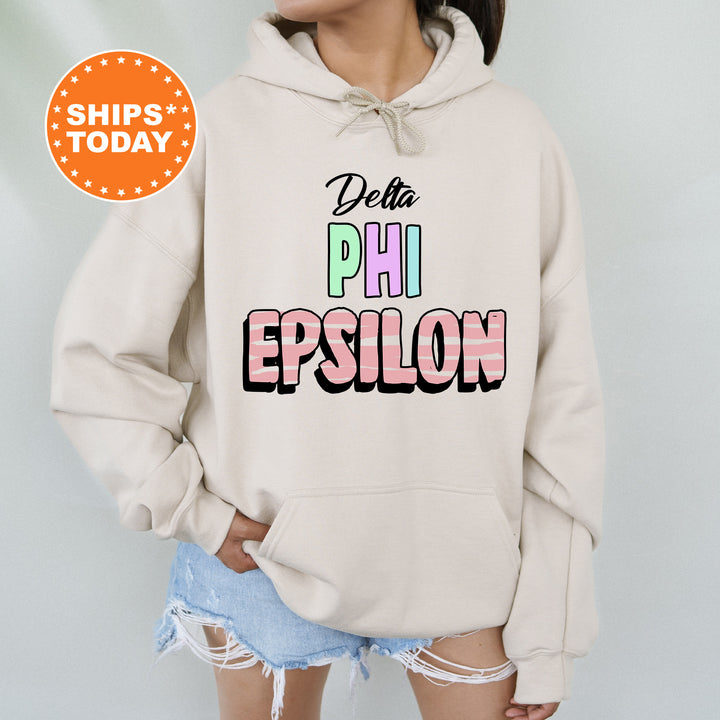 a woman wearing a sweatshirt that says delta phi epsilon