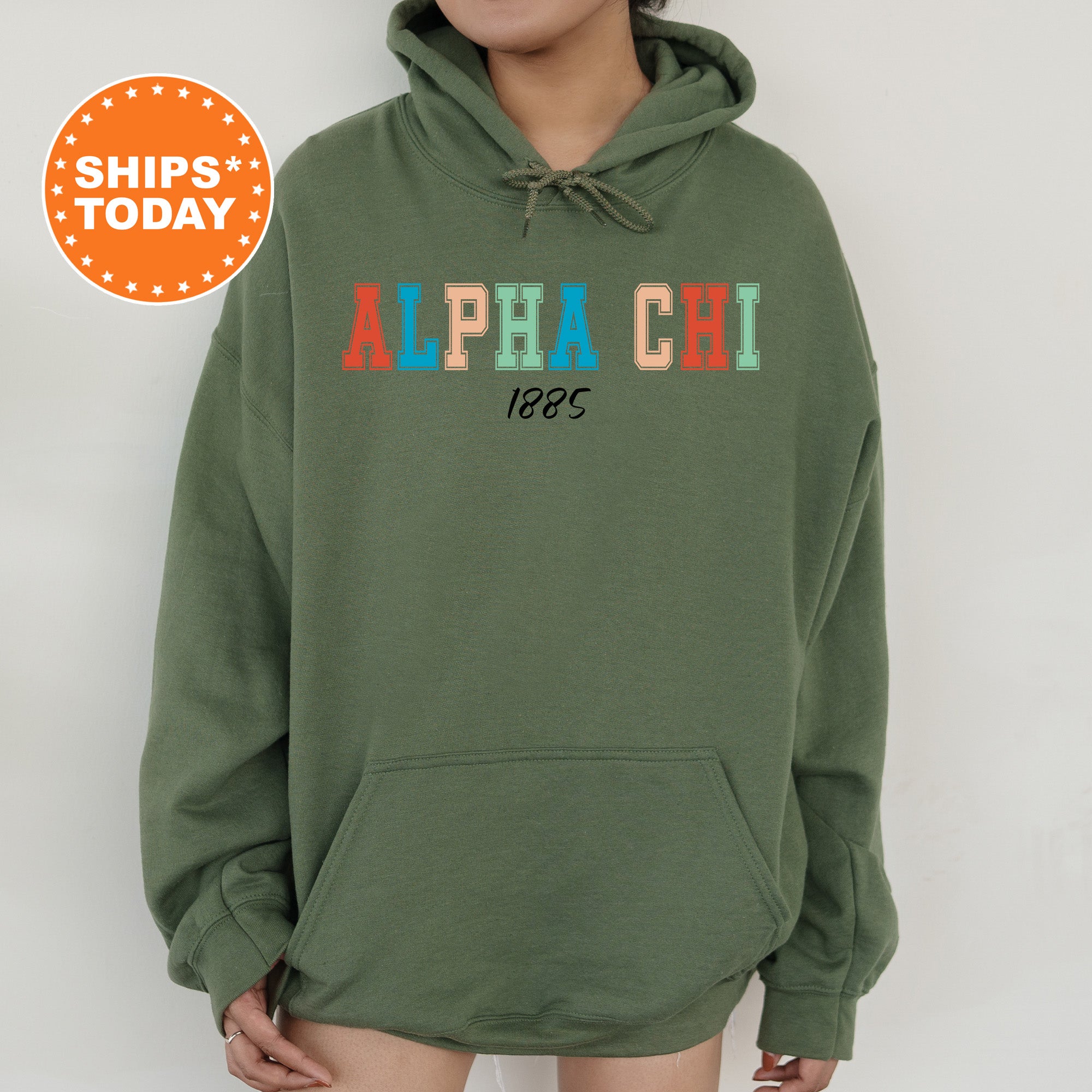 a woman wearing a green hoodie with the words alphachi on it