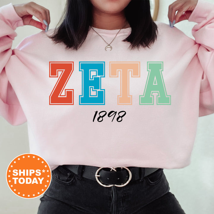 a woman wearing a pink sweater with the word zeta printed on it